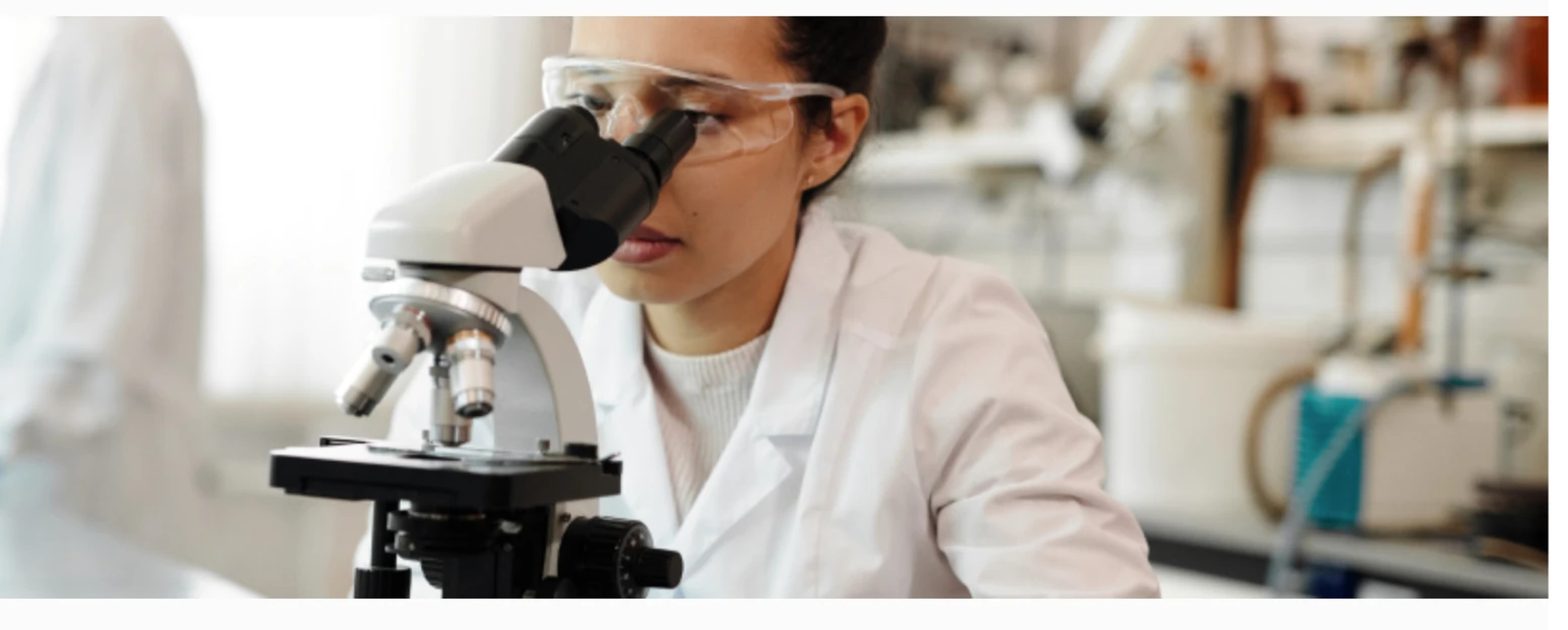 Researcher working with a microscope in the dasso laboratory